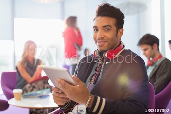 Portrait confident young male college student with digital tablet
