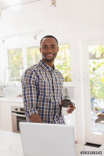 Portrait confident young man with laptop working from home