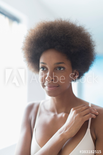 Portrait confident young woman with afro in bra