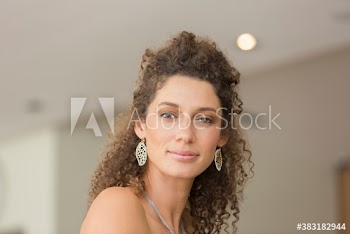 Portrait confident young woman with curly hair
