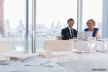 Portrait corporate business people using laptop in restaurant