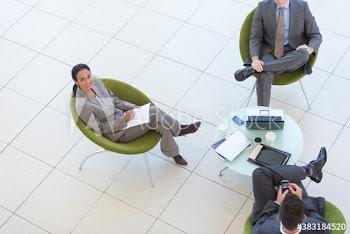 Portrait corporate businesswoman meeting with colleagues in lobby