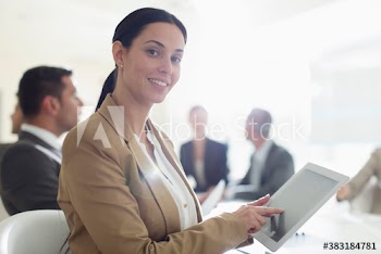 Portrait corporate businesswoman using digital tablet in conference room meeting