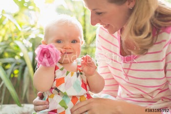 Portrait cute baby daughter and mother with pink rose