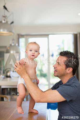 Portrait cute baby son and father at dining table