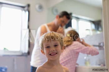 Portrait cute boy in bathroom with family