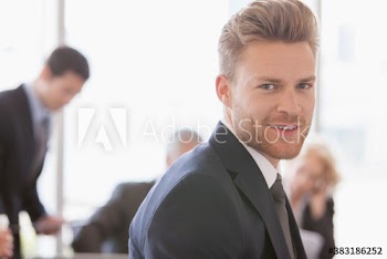 Portrait handsome young corporate businessman in meeting