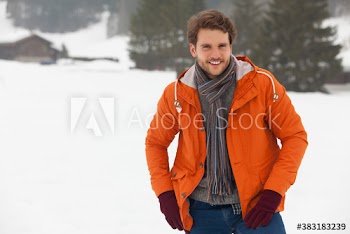 Portrait handsome young man in snow