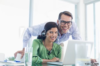 Portrait happy business people using laptop
