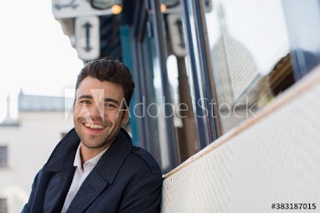 Portrait happy businessman at sidewalk cafe