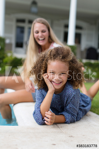 Portrait happy carefree girl at poolside