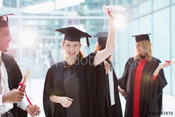 Portrait happy college students in caps and gowns graduating