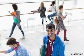 Portrait happy confident young male college student