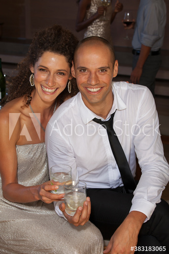 Portrait happy couple drinking cocktails at party
