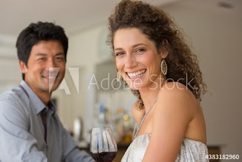 Portrait happy couple drinking red wine