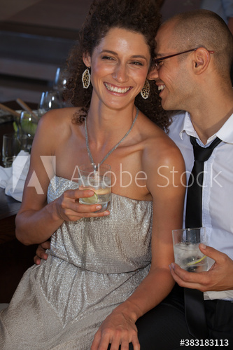 Portrait happy couple enjoying cocktails at party