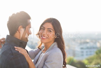 Portrait happy couple hugging outdoors
