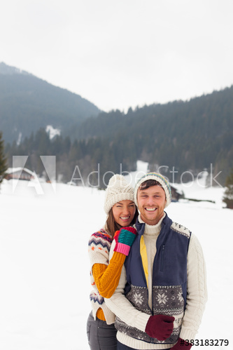 Portrait happy couple in warm clothing in snowy field