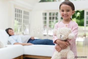 Portrait happy cute girl with teddy bear near pregnant mother