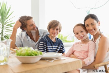 Portrait happy family eating at patio table