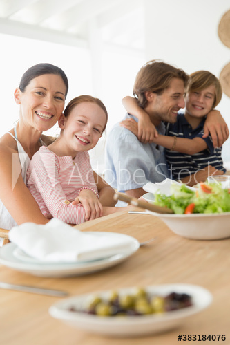 Portrait happy family eating lunch at table