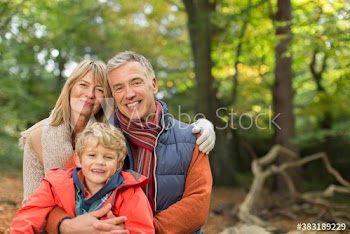 Portrait happy family in autumn woods