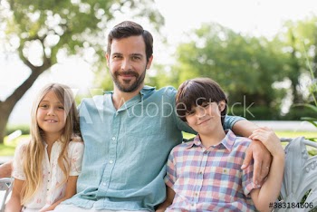 Portrait happy father and children on bench