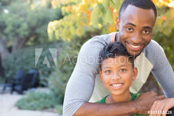 Portrait happy father and son on patio