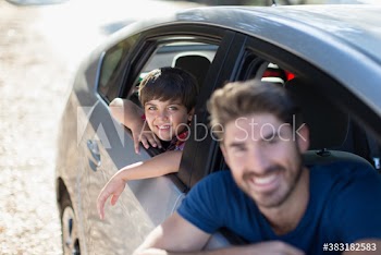 Portrait happy father and son riding in car