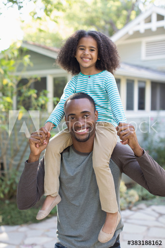 Portrait happy father carrying daughter on shoulders