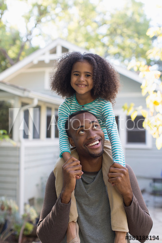 Portrait happy father carrying daughter on shoulders