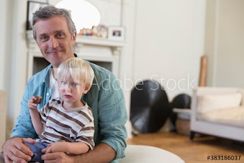 Portrait happy father holding son
