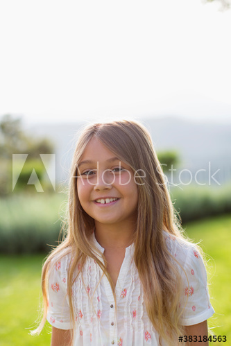 Portrait happy girl in sunny backyard