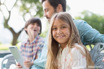 Portrait happy girl with father and brother on bench