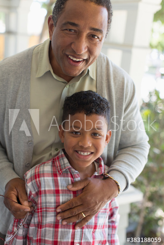 Portrait happy grandfather and grandson hugging