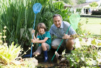 Portrait happy grandfather and grandson with fishing nets