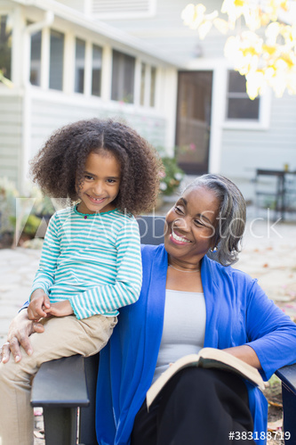 Portrait happy grandmother and granddaughter on patio