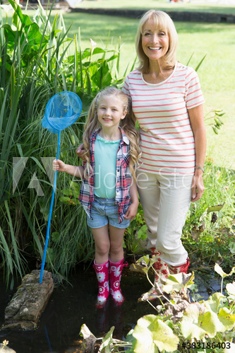 Portrait happy grandmother and granddaughter with fishing net