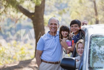 Portrait happy grandparents and grandkids enjoying road trip at car