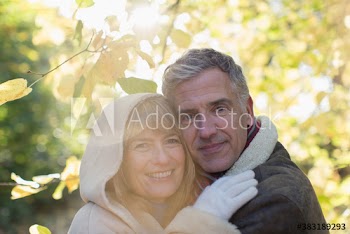 Portrait happy mature couple hugging in park