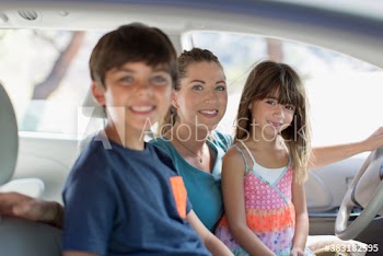 Portrait happy mother and children inside car