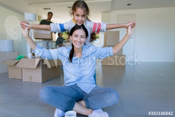 Portrait happy mother and daughter moving into new house