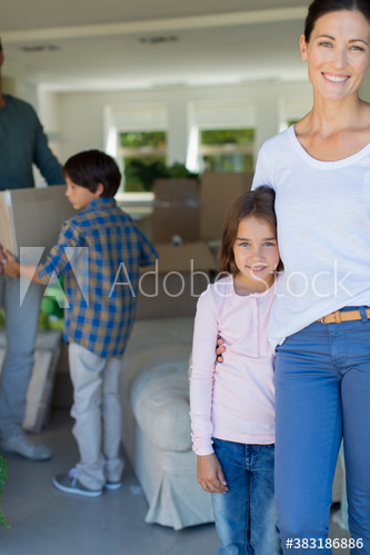 Portrait happy mother and daughter moving into new house