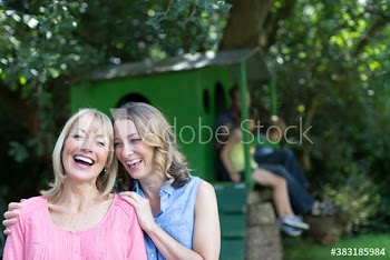 Portrait happy mother and daughter with family at treehouse