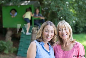 Portrait happy mother and daughter with kids in backyard