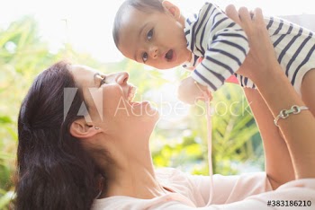 Portrait happy mother holding cute baby son