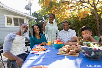 Portrait happy multi-generation family enjoying lunch on autumn patio