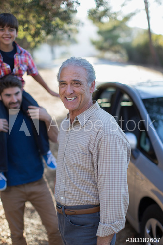 Portrait happy multi-generation family outside car