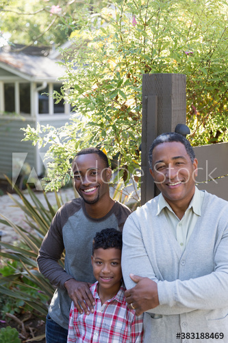 Portrait happy multi-generation men in backyard