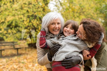 Portrait happy multi-generation women in autumn woods